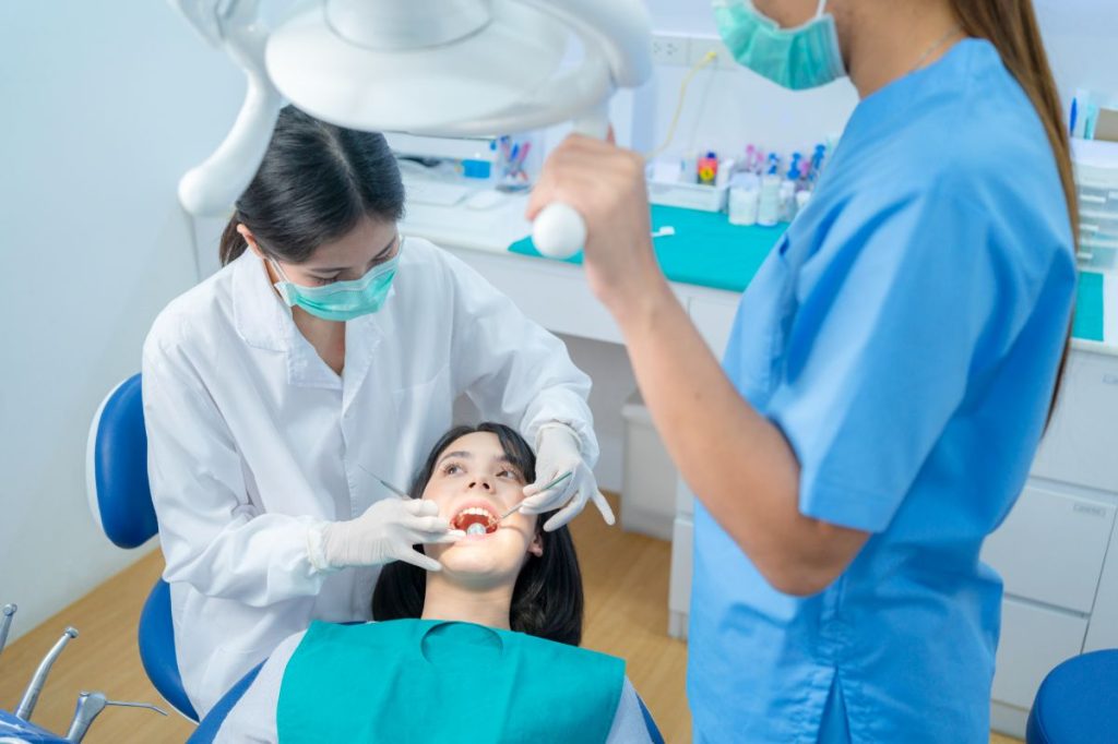 Asian Female Dentist Checking Or Examining Tooth O 2021 12 09 20 23 33 Utc 1 1024x682